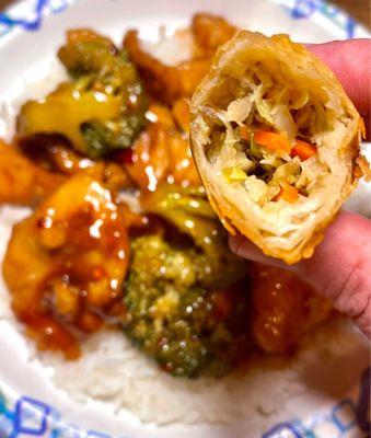 Chicken with Garlic Sauce over white rice with veggie spring roll showing filling