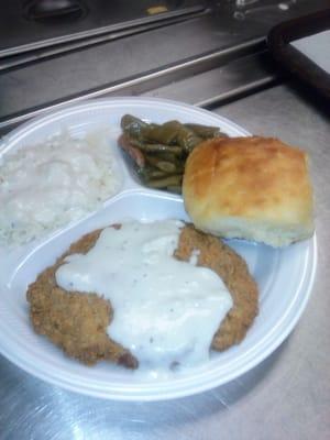 Country fried steak rice and gravy green beans and biscuit.