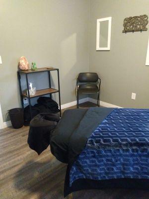 Serene and inviting treatment room with a heated table.