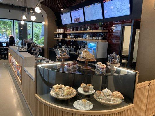 Dilettante Mocha Café Pastry case featuring cupcakes, cookies, scones, croissants, and brownies