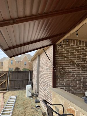 Backyard home improvement with a flagstone wall and bar.