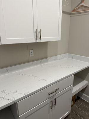 Laundry room quartz folding counter.