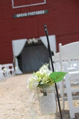 Fabric backdrop, chairs and aisle decor provided.