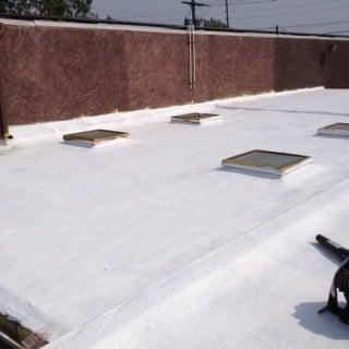 Silicone roof coating over foam roof system.