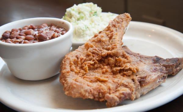 Pork Chops (one fried, one grilled) with homemade slaw and pinto beans.