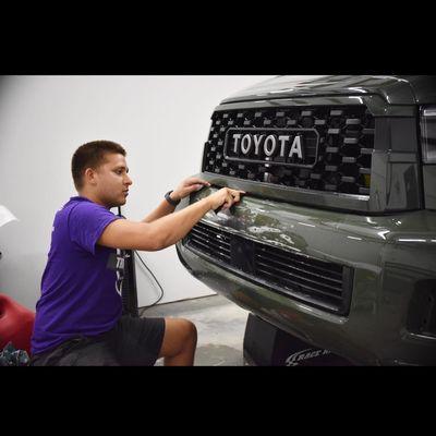 Installing paint protection film on bumper.