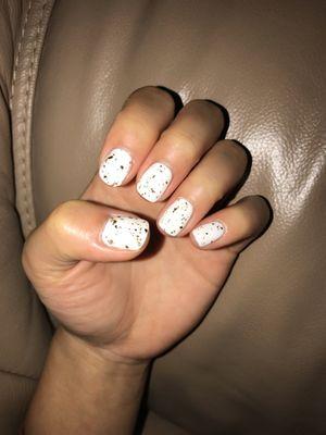 White with gold flakes gel manicure