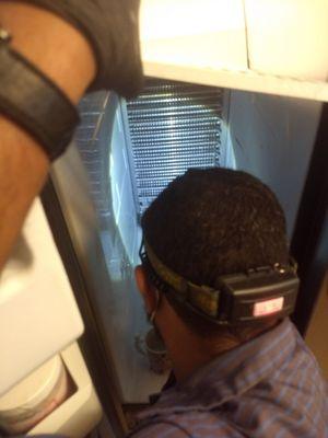 Kevin removing the back panel of our 11 year old Kitchen Aid refrigerator