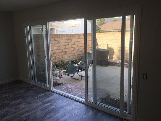 beautiful 12' patio door -Dual pane glass, tinted with two doors and screens in center of opening.