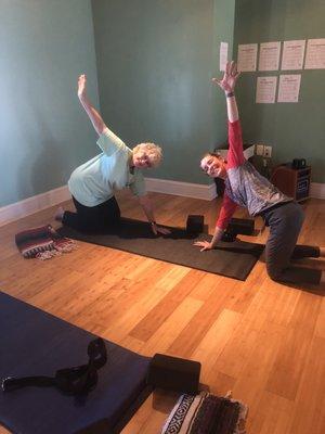 Student and teacher smiling at Loft Yoga.