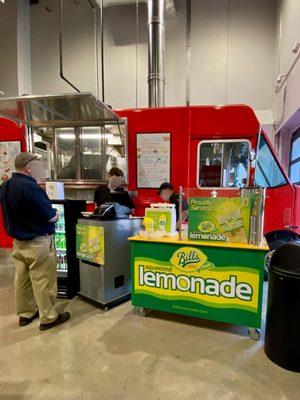 Now Serving Lunch. "Food Truck" inside the store & LEMONADE Stand.