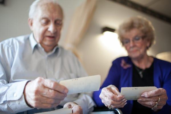 A resident and his wife look over some photos.