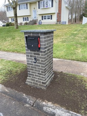 Brick mailbox with stone cap