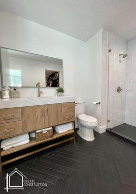 bathroom_addition._Complete_remodeling._bathroom_remodeling._walking_shower_remodel._black_and_white_bathroom_remodel._black_herringbone_til