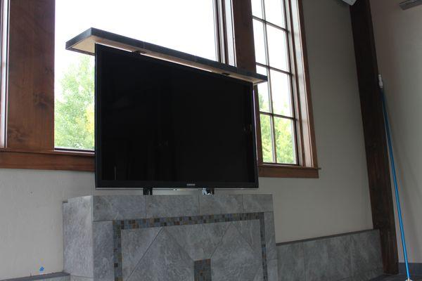 when it comes to automation why not conceal your TV and have it raise when you want to watch it!