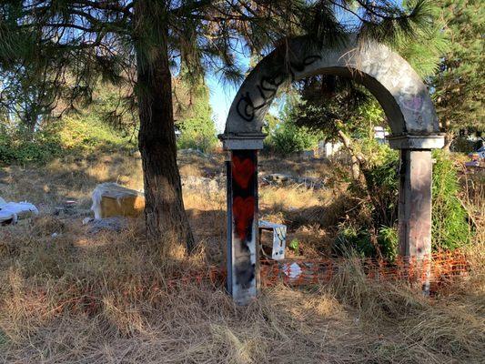 Abandoned and trashed lot with needles and homeless encampment owned by Thomas James Homes