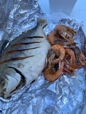 Cleaned Pompano fried whole with wild shrimp fried head on.