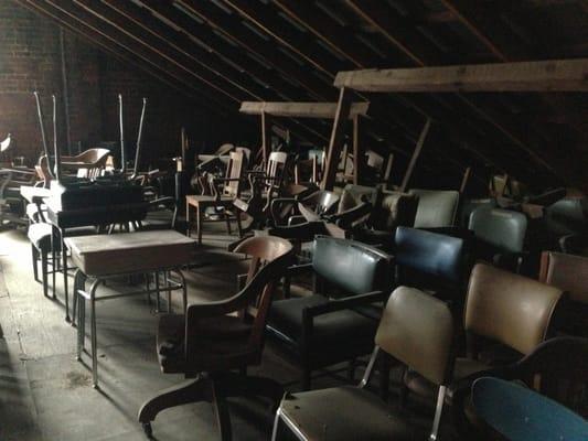 Deadly attic full of vintage chairs worth reconditioning.