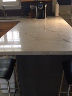 Beautiful installation of a new quartz countertop, granite side panel with perfect finish work.