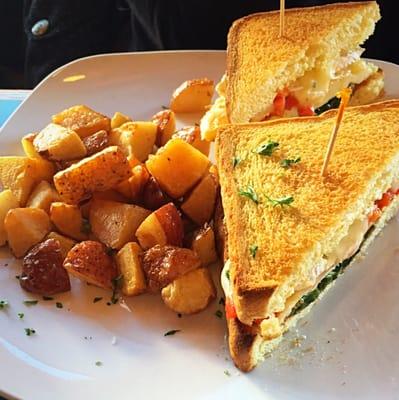 Egg Sandwich - two fried eggs, brie, roasted red pepper,sautéed spinach, Texas white and a side of  breakfast potatoes ($10)