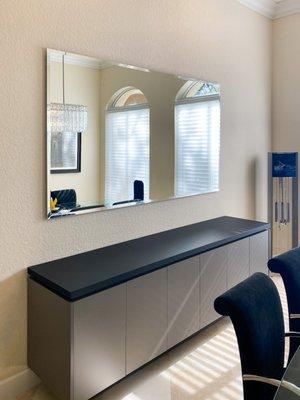 Floating beveled wall mirror.