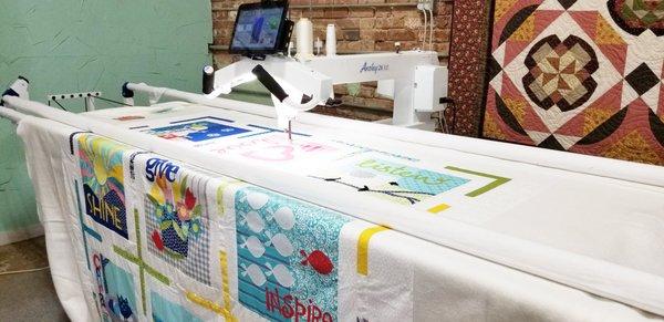 Our Imagine quilt by Art to Heart has been loaded on to the Handi Quilter for quilting!