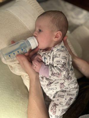 Sweet baby learning how to drink from the bottle.