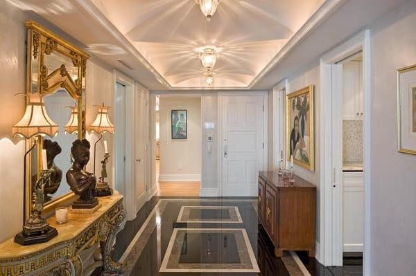 Tray ceiling with illuminated groin arches, Venetian plastered walls, marble patterned entry