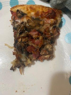 Cheese with extra mushrooms and bacon. Everything including the crust cooked and stretched by hand to the perfect crust