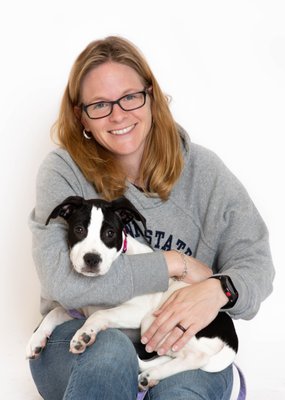 A puppy on adoption day with its new owner.