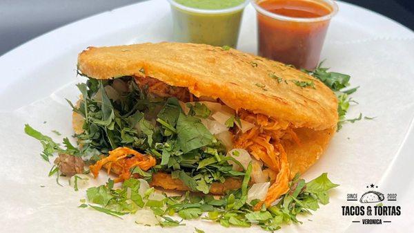 Traditional Mexican dish that consists of a thick, round, and flattened corn cake or tortilla that is stuffed with a variety of fillings