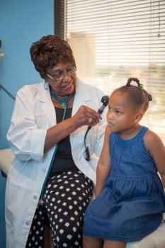 Dr. Williams-Neal examining the inner ear of one of her patients.