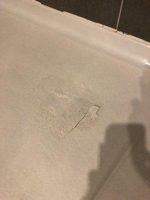 Shower pan in bathroom showing how a guest can cut their feet.