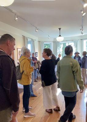 Artist Anne Milligan with visitor discussing her latest collection of works