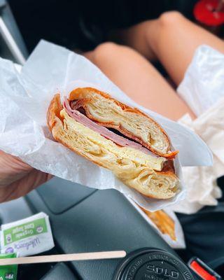 Croissant sandwich w/ bacon, ham & egg