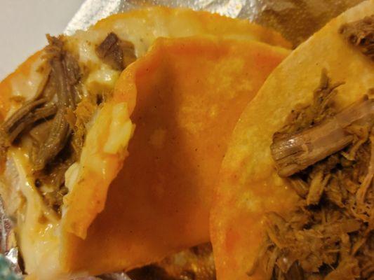 Inside the quesabirria taco (left) & the birria taco (right)