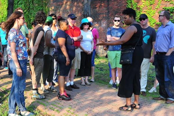 Performer Bria Walker leads participants in Saints Tour, a immersive, mobile experience in Braddock, Pa.