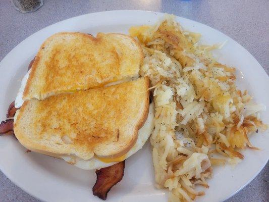 Breakfast sandwich with a side of hashbrowns