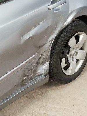 Rear damages to tire area on Nissan Altima