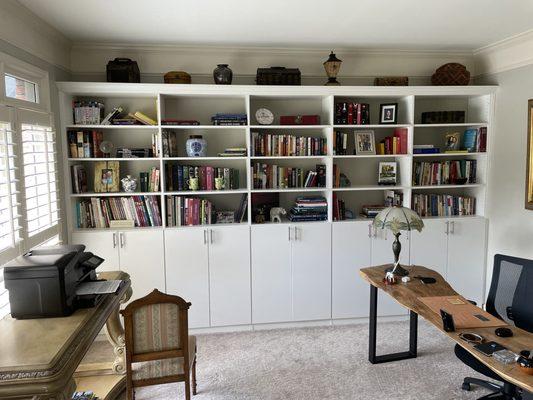 Installation of Billy-bookcase style cabinet with crown molding added to top to give the look of a built-in cabinet.