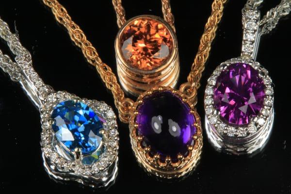 Wide variety of colored gemstone pendants to choose from! Pictured are imperial zircon, blue zircon, amethyst, and umbalite garnet.