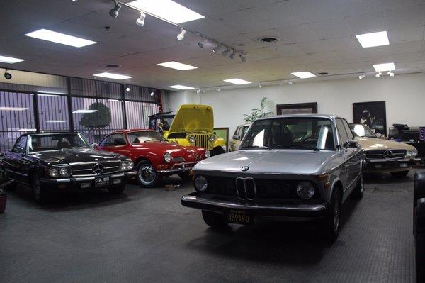 Showroom.  1976 BMW 2002cc  1989 Mercedes Benz 560 SL 1971 Volkswagen Karmann Ghia  1972 Jeep CJ-5