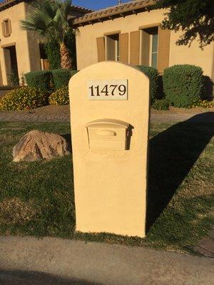 Sprucing up a mailbox with some new stucco and paint