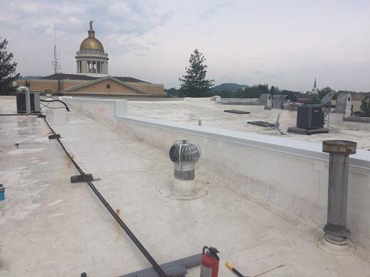 New wall coping to protect dividing wall on downtown building.