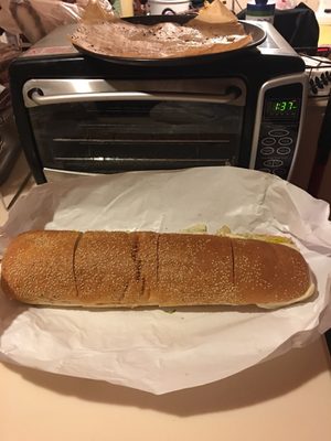 Full size Italian hoagie    It's sitting in front of a full size convection oven!