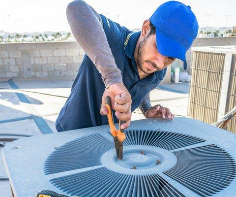 AC technician finishing commercial service successfully