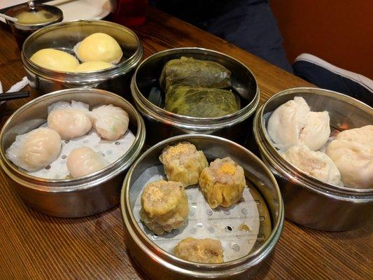 Custard bun, shrimp dumpling, chicken wrapped in rice, shumai,  pork bbq bun