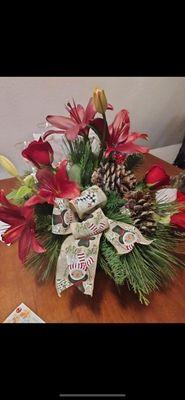 Beautiful lilies, pine and bow my Christmas and New Year's greeting to my family in Idaho pleasantly surprised great job recommend