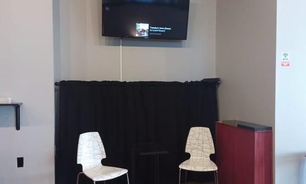 Sitting area (much more not captured). Also, a tv showing what song is playing throughout the shop.