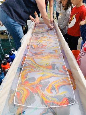 GOSF 2019 - Vendor - Midnight Star Pottery - paint transfer to scarf on water.